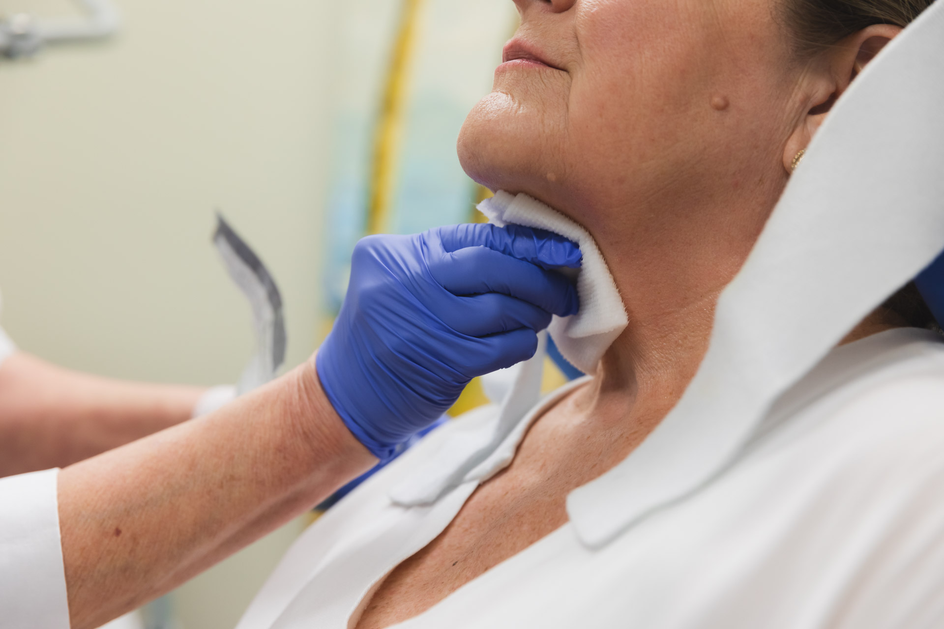 A Phases provider prepares a patient's submental area for CoolSculpting, a less invasive and lower-cost alternative to double chin surgery in Indianapolis.