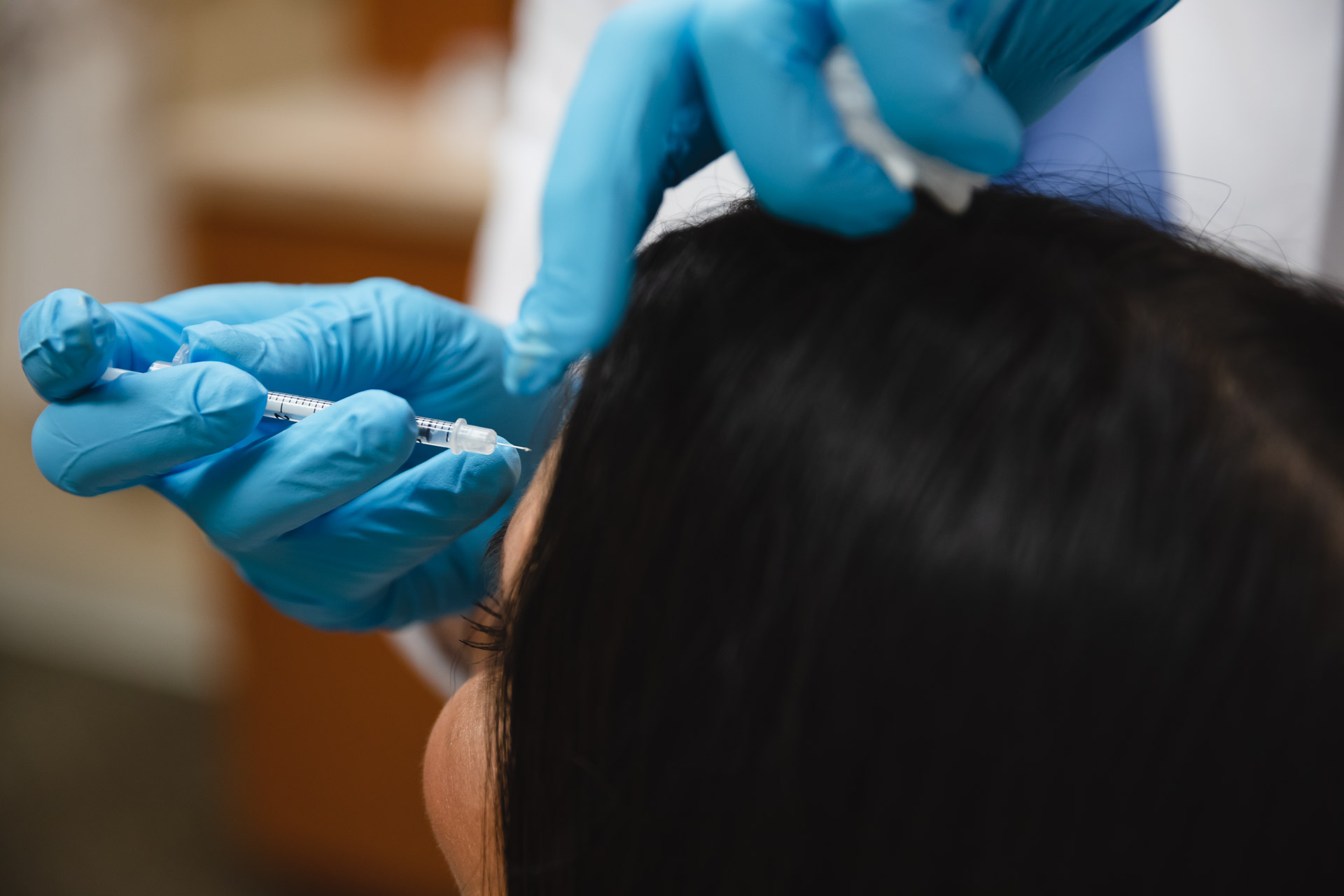 A provider administers a patient's forehead Botox near Fishers.