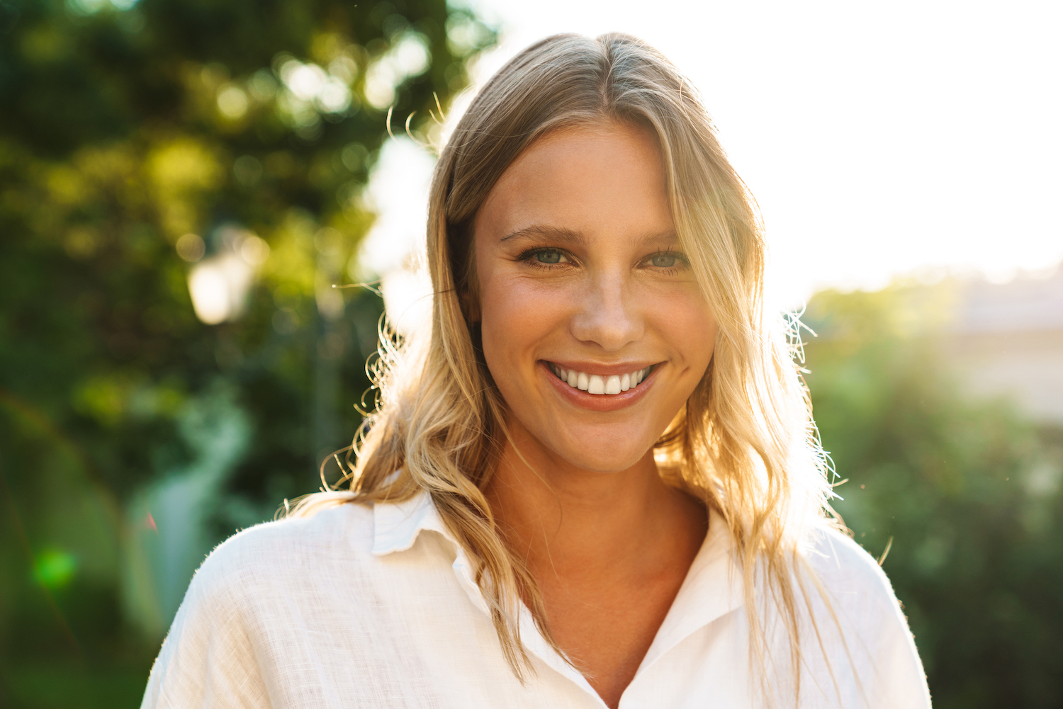  A woman smiles, enjoying her radiant complexion after a Hydrafacial near Fishers.