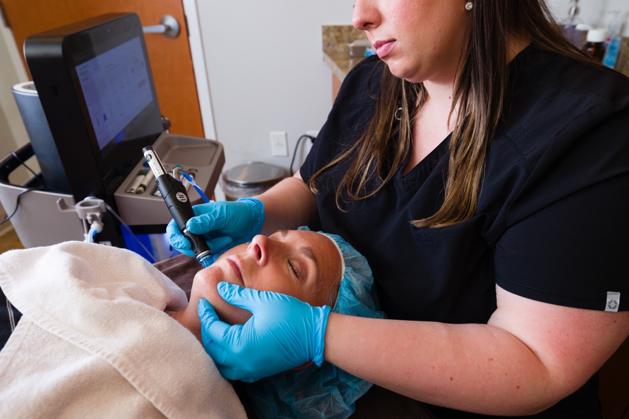 During a Hydrafacial near Noblesville, an aesthetician uses the handpiece to infuse serums into the skin.