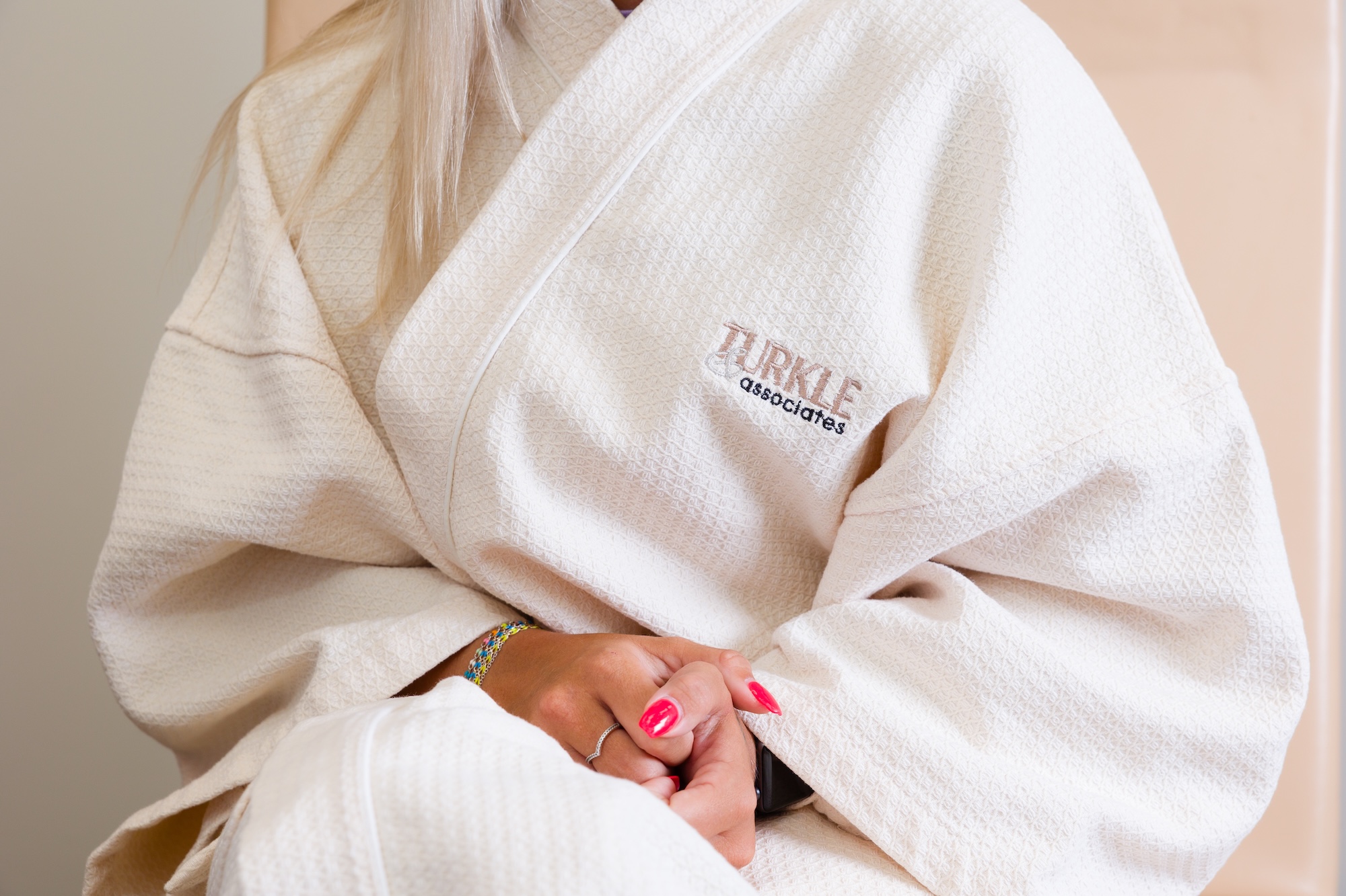 A patient wears a Turkle & Associates robe in the treatment room prior to her stomach tuck in Indiana.