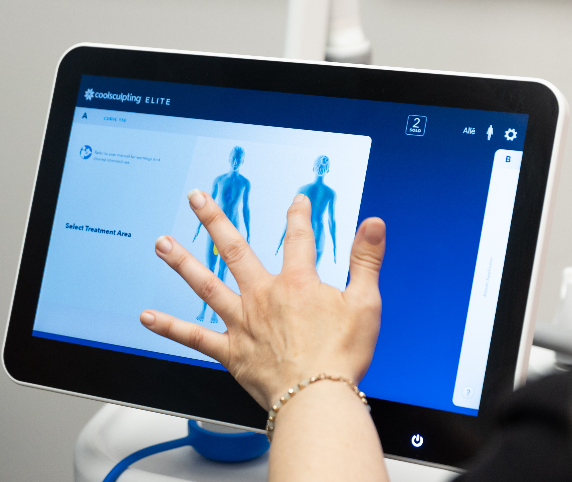 A provider prepares the device settings for a patient's CoolSculpting near Westfield.