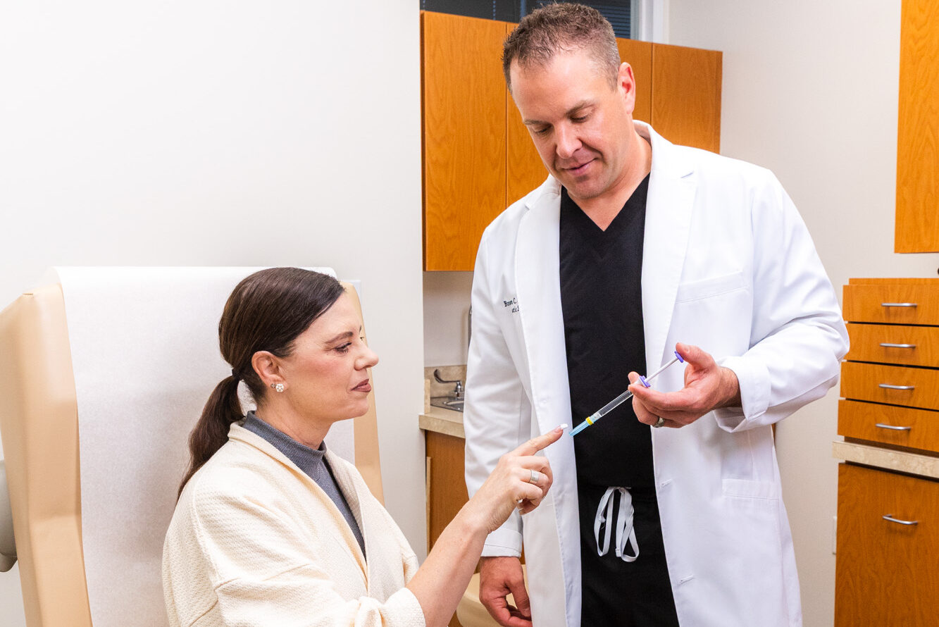 Dr. Specht consults with a patient to discuss additional injectable treatments alongside her microneedling in Carmel.
