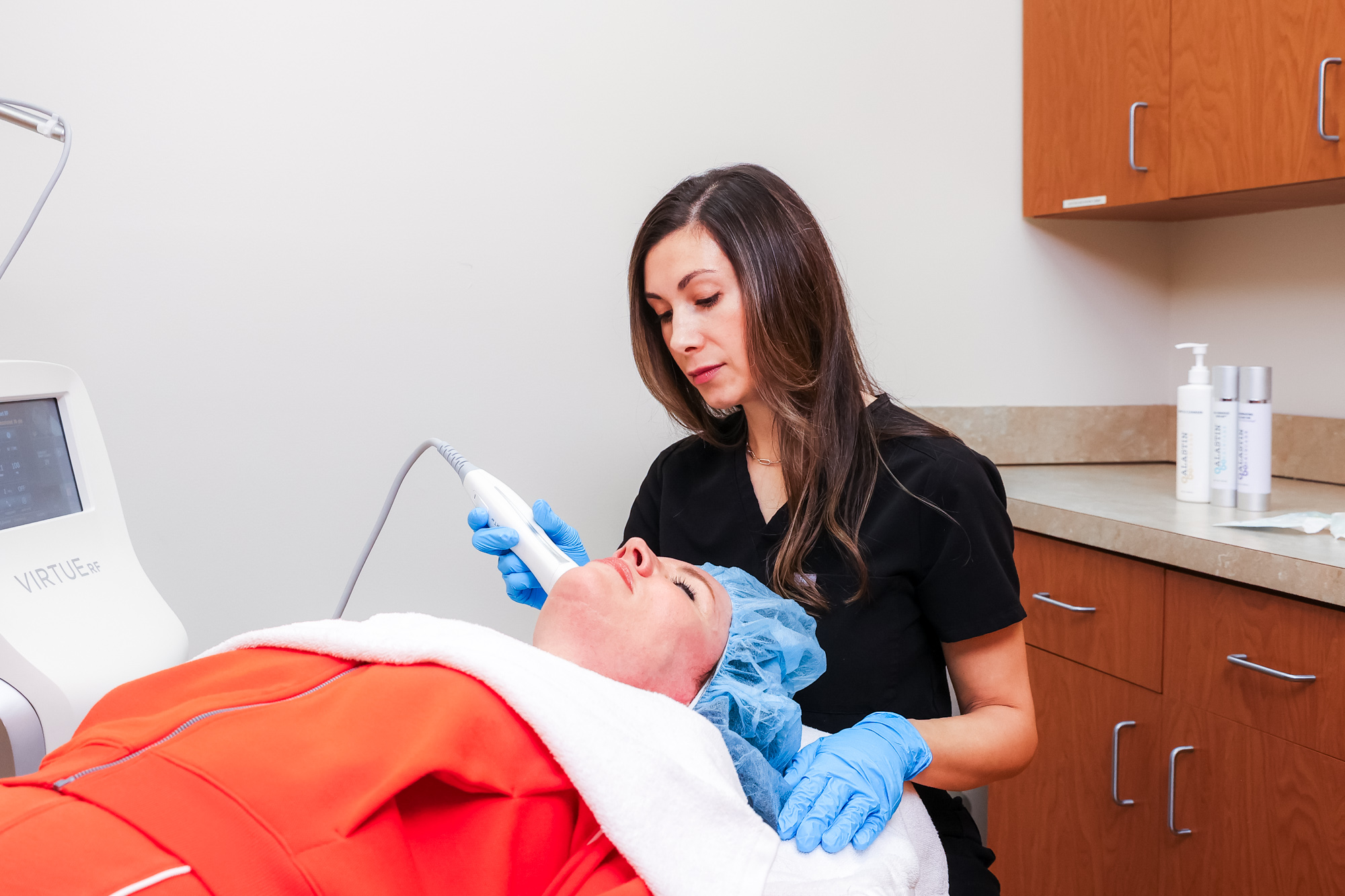 An aesthetician applies the Virtue RF microneedling device during facial skin tightening in Indiana.