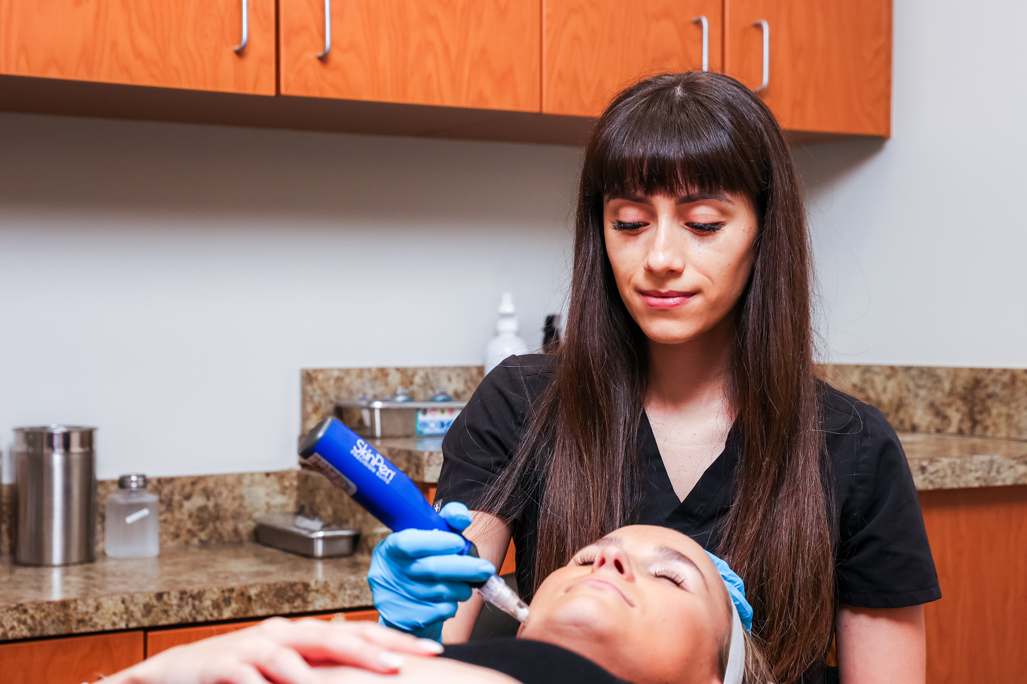 A licensed medical aesthetician administers a patient's facial microneedling near Westfield.