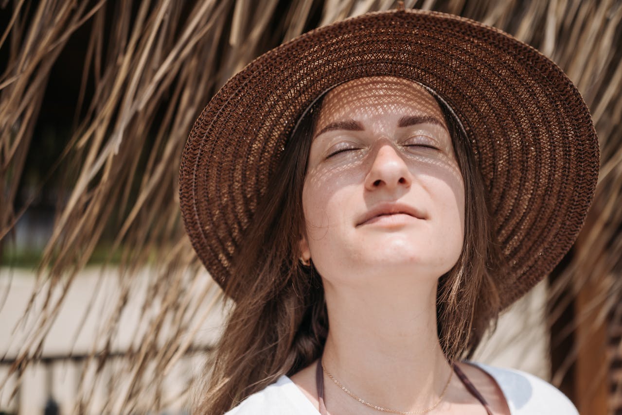 A woman basks in the sunlight, a habit that later leads her to seek skin rejuvenation with microneedling in Carmel.